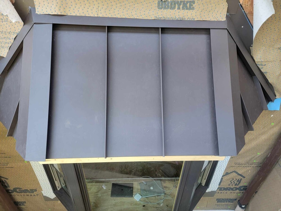 Workers installing a new roof on a house with professional tools